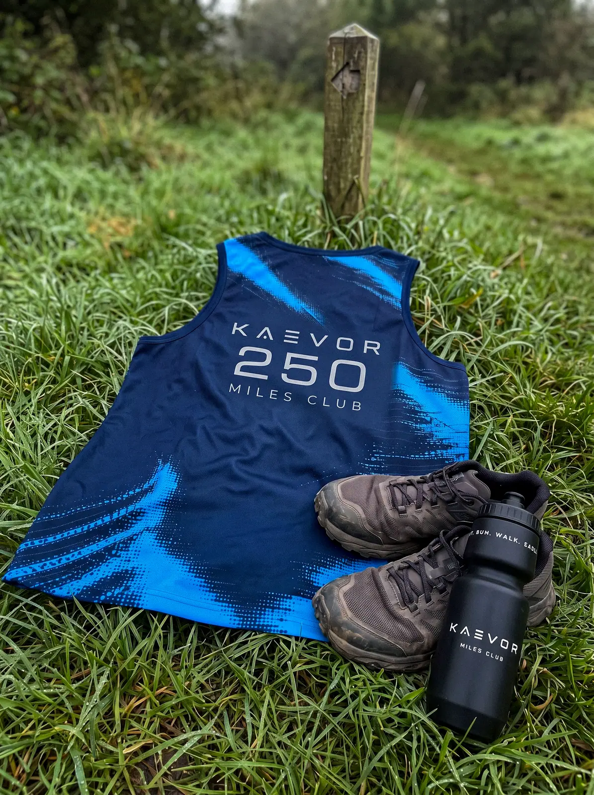 Kaevor vest, shoes and bottle on the grass